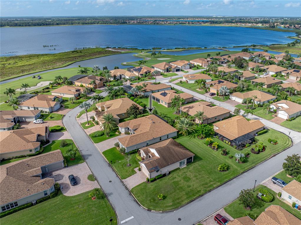 4004 Sable Loop Drive Lake Wales, FL 33859 - Photo 68 of 94 an aerial view of a house with a garden and lake view