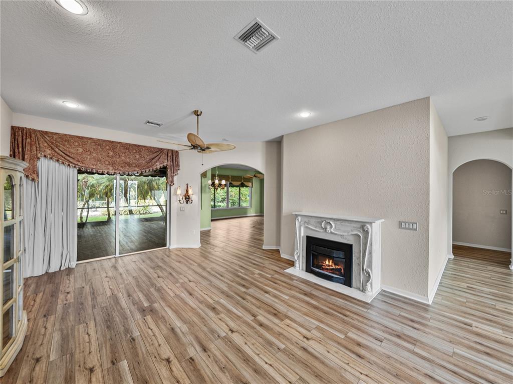 4004 Sable Loop Drive Lake Wales, FL 33859 - Photo 8 of 94 a open kitchen view with fireplace and wooden floor