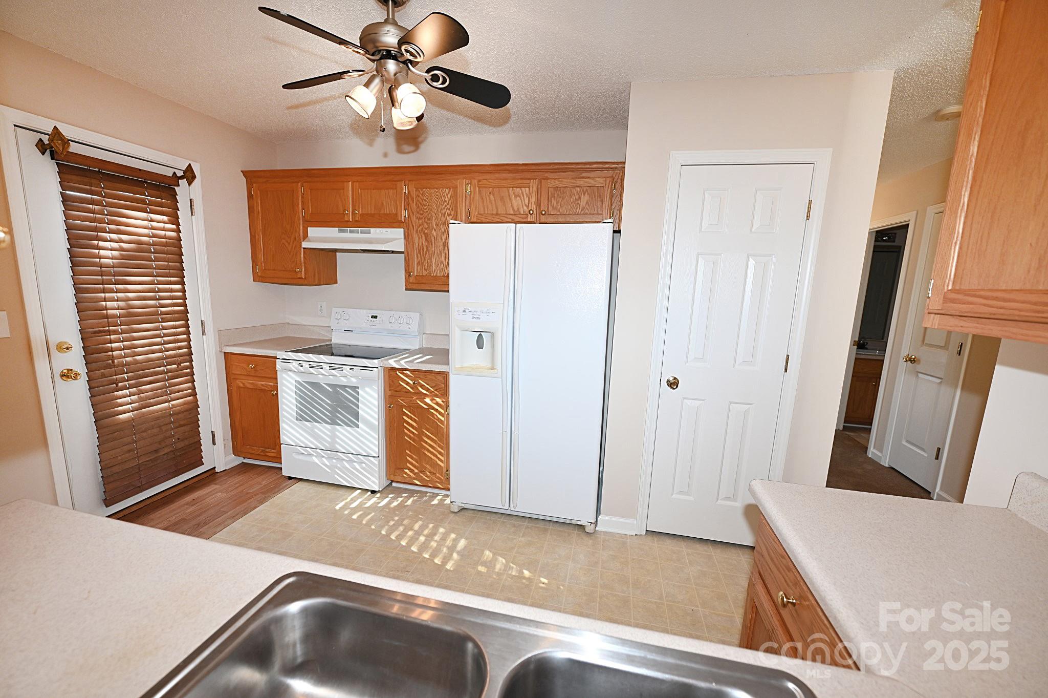 621 23rd Street Northwest Hickory, NC 28601 - Photo 12 of 35 a view of a kitchen with a sink and a ceiling fan