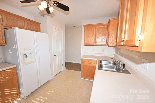 a kitchen with stainless steel appliances a refrigerator and a sink