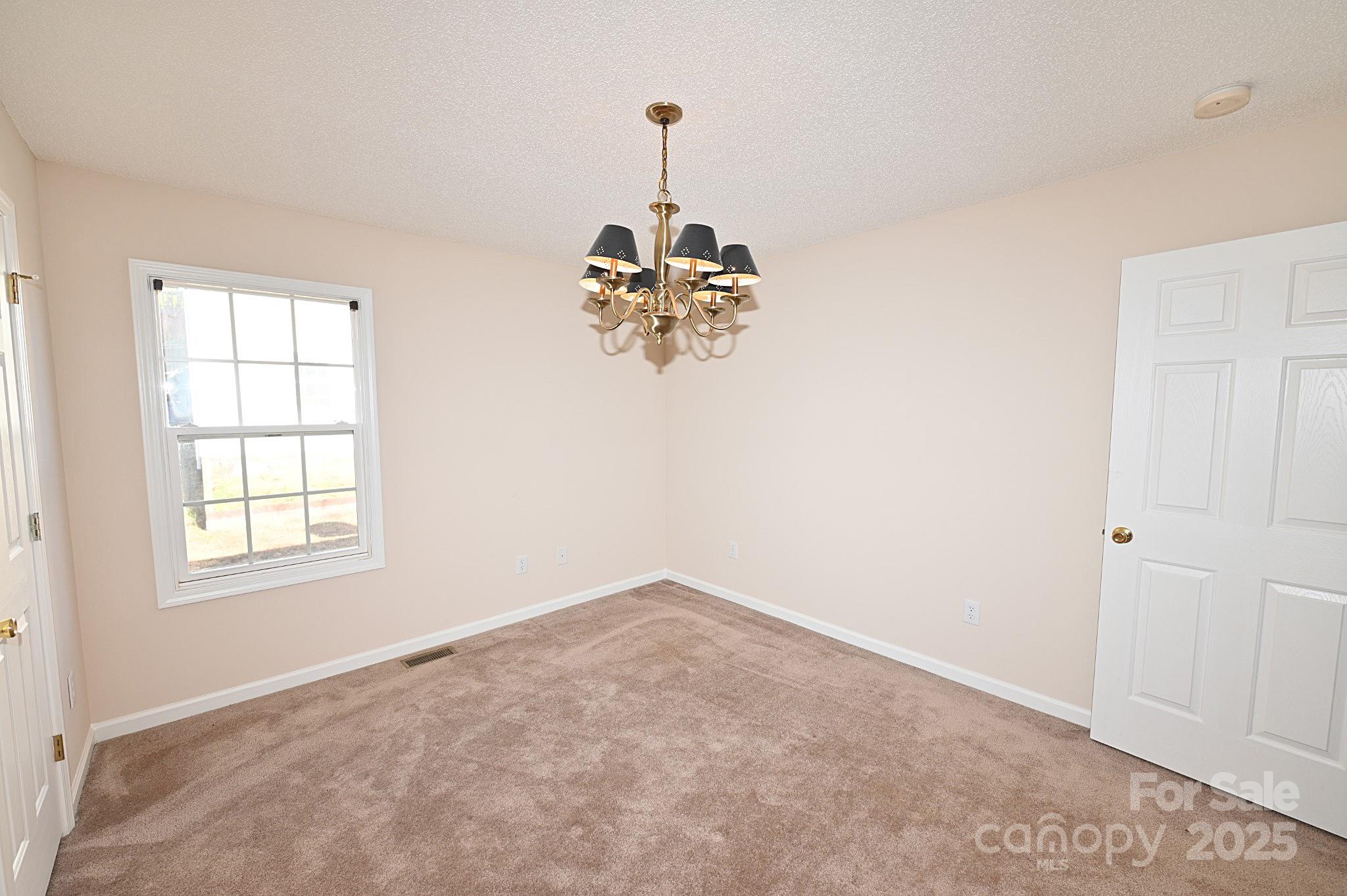 621 23rd Street Northwest Hickory, NC 28601 - Photo 21 of 35 an empty room with windows and chandelier fan