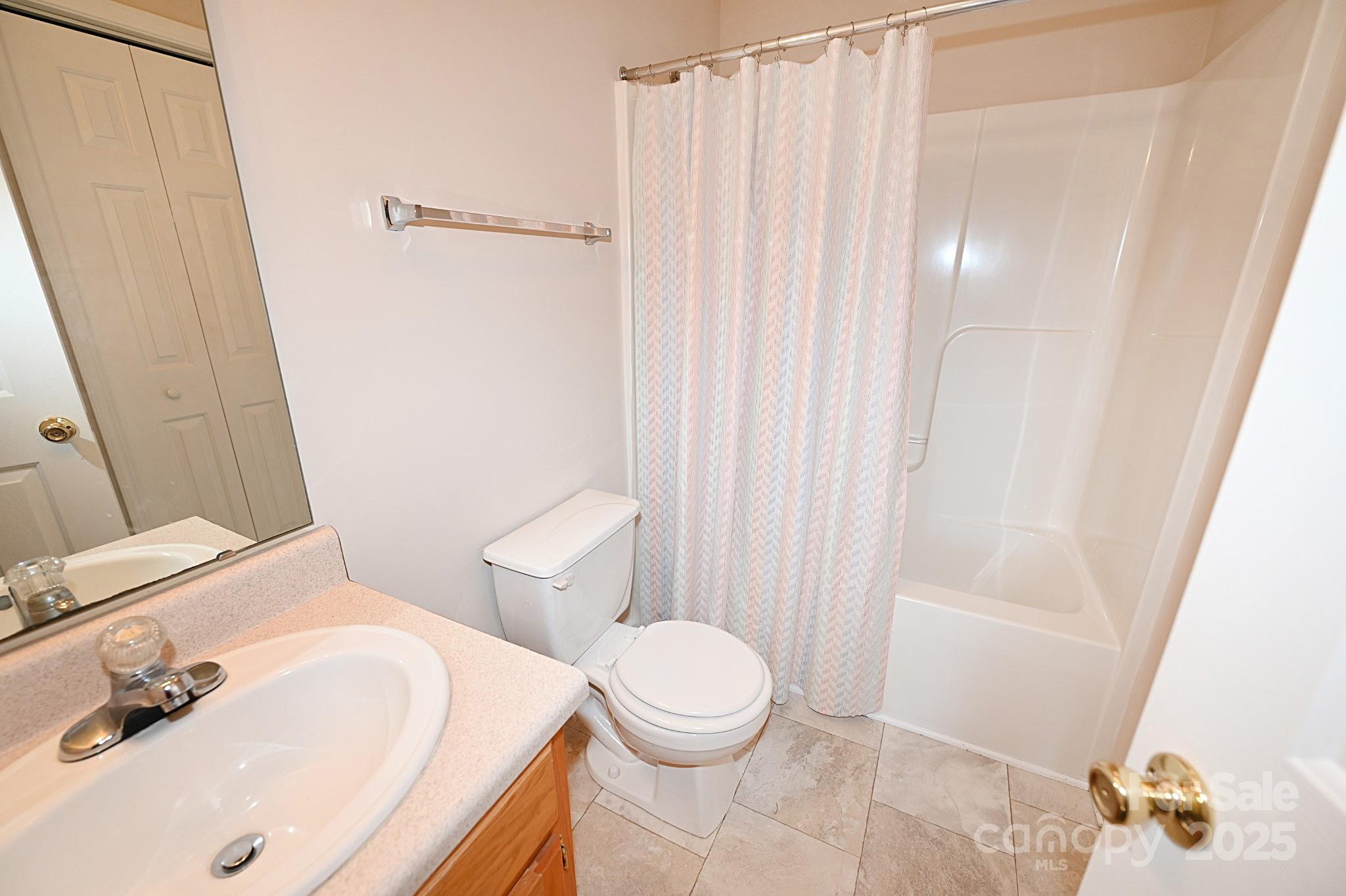 621 23rd Street Northwest Hickory, NC 28601 - Photo 27 of 35 a bathroom with a sink a toilet and shower curtain