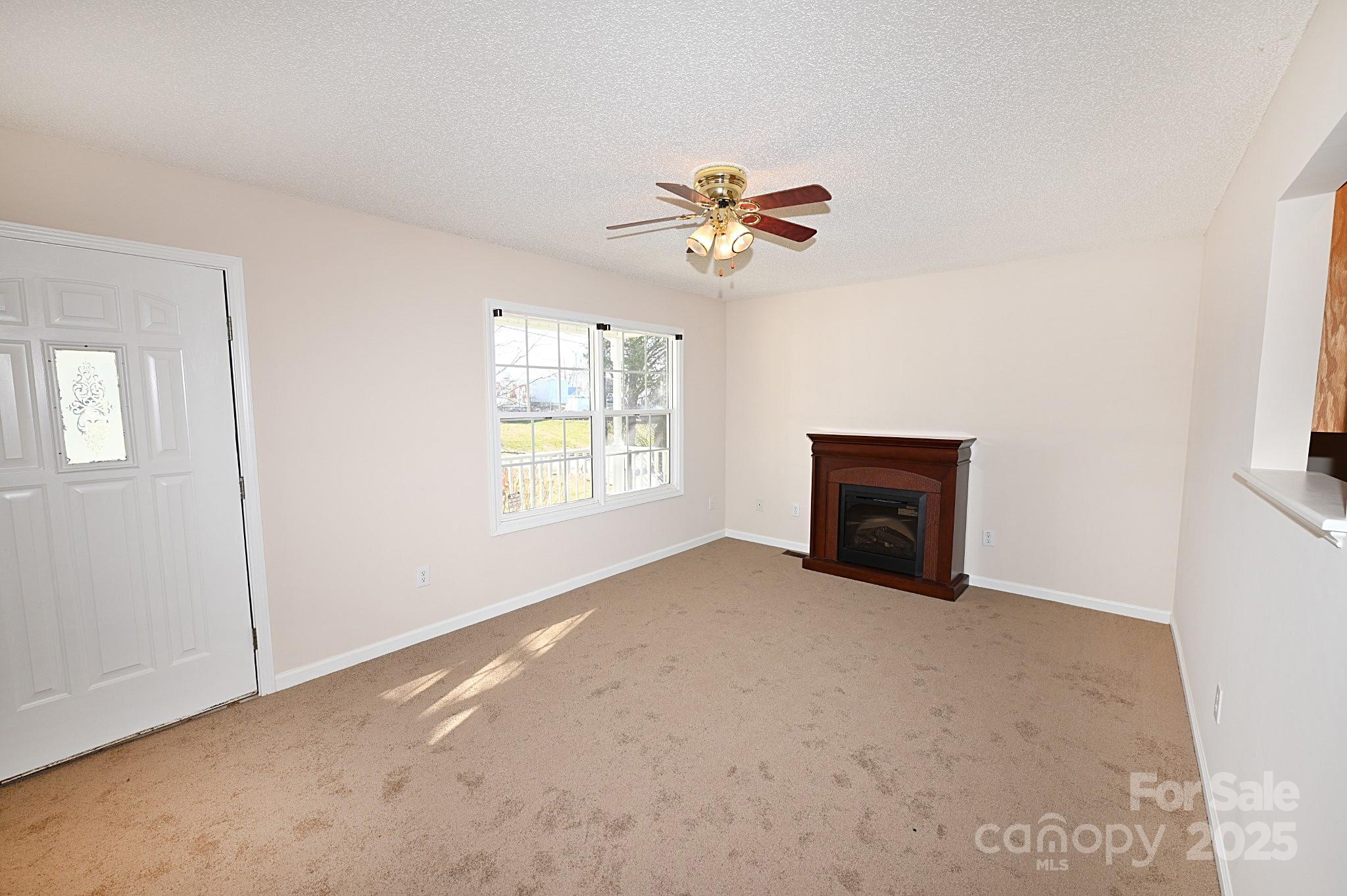621 23rd Street Northwest Hickory, NC 28601 - Photo 5 of 35 an empty room with windows and fan