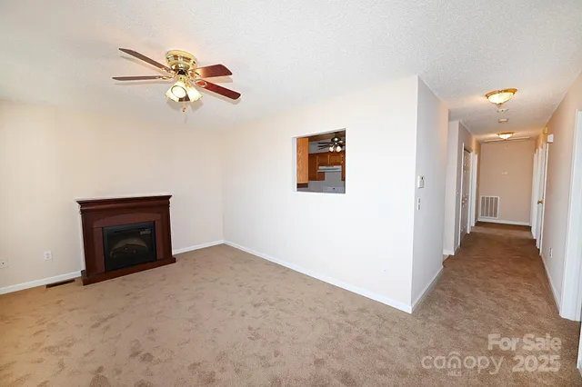 a view of a livingroom with a ceiling fan and chandelier fan
