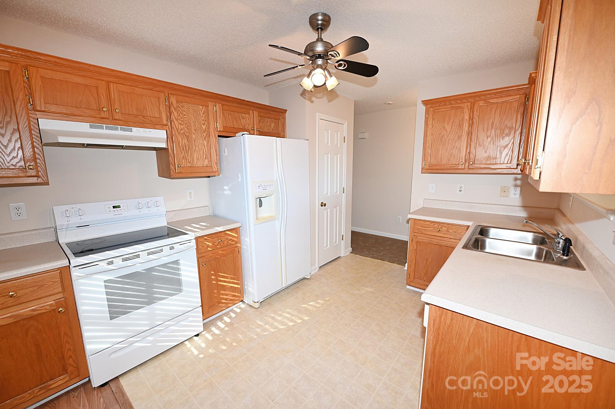 621 23rd Street Northwest Hickory, NC 28601 - Photo 10 of 35 a kitchen with stainless steel appliances a stove a sink and a refrigerator