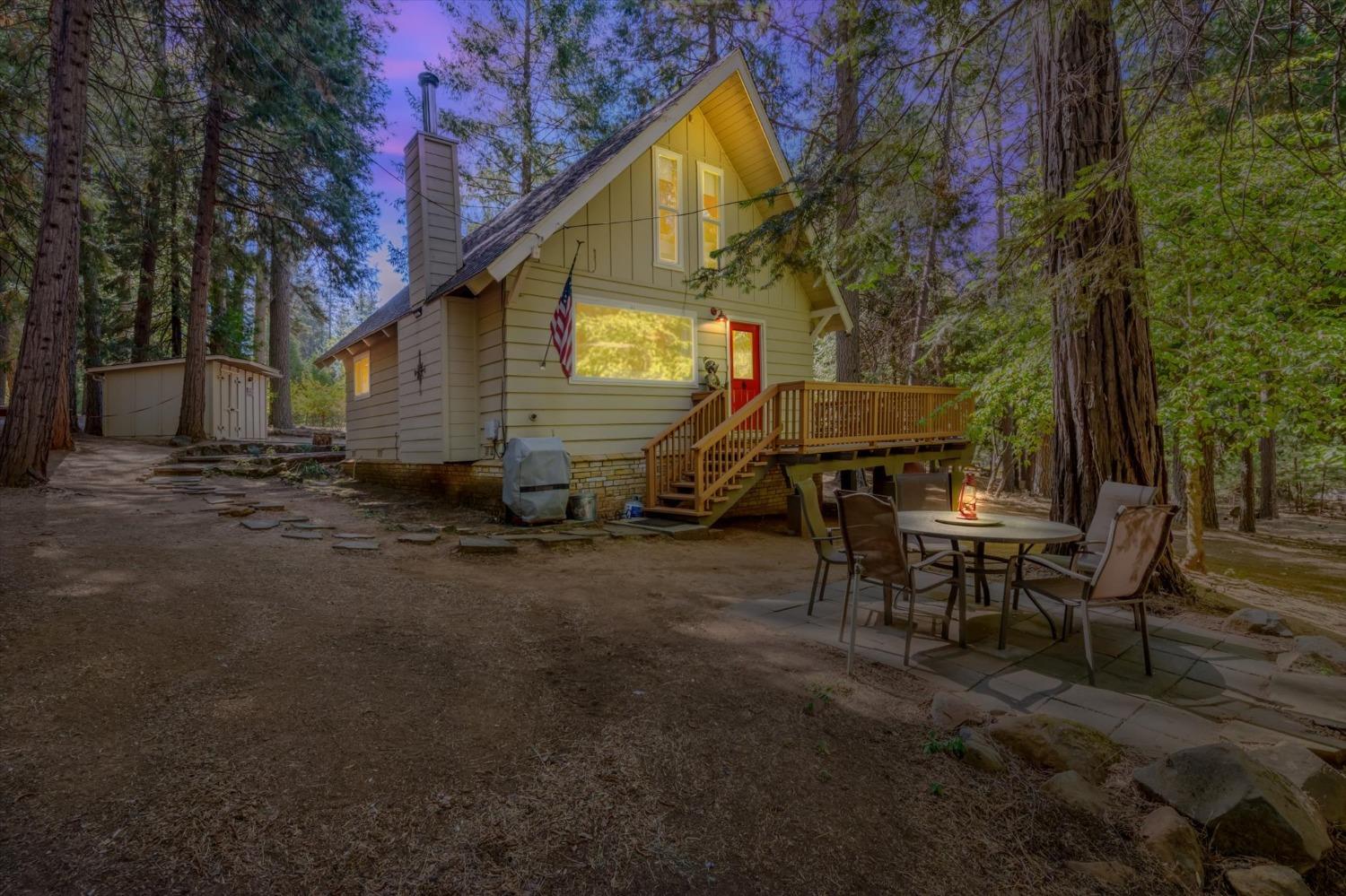 a view of a house with backyard and sitting area
