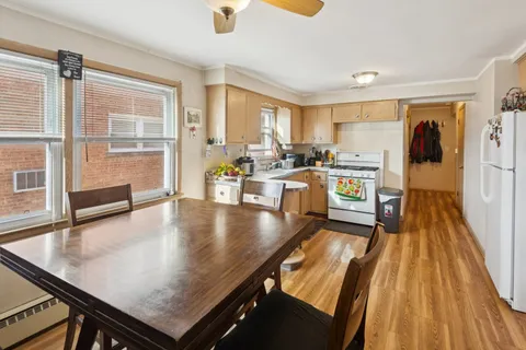 a living room with stainless steel appliances furniture stove and a table