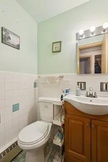 a bathroom with a sink toilet and a mirror