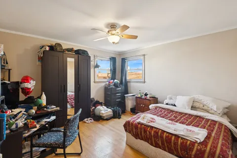 a bedroom with bed and a chandelier