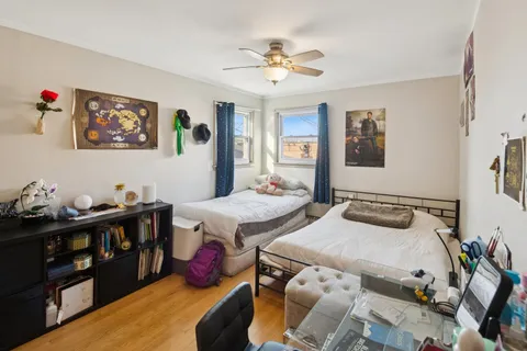 a bedroom with two beds and a chandelier