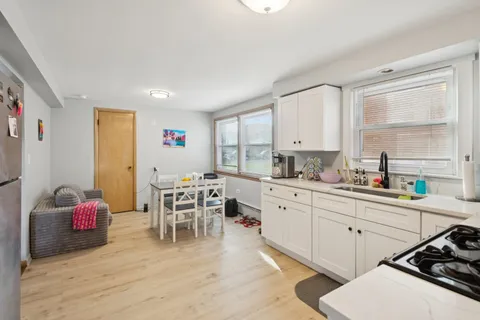 a kitchen with a sink stove and cabinets