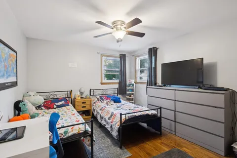 a bedroom with furniture and a flat screen tv