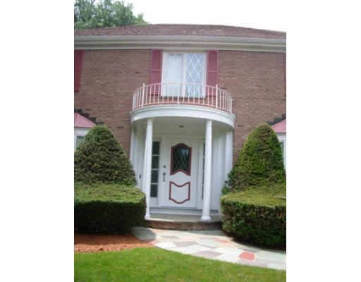 12 Paddock Lane Lexington, MA 02421 - Photo 3 of 18 a front view of a house with a garden