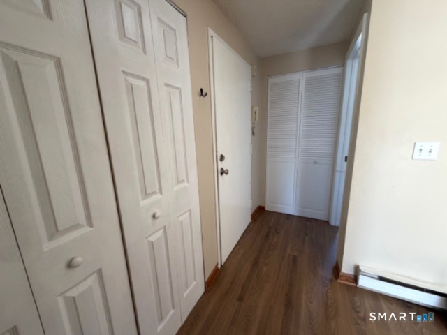 113 Heather Ridge, Unit 113 Shelton, CT 06484 - Photo 12 of 19 a view of a hallway with wooden floor