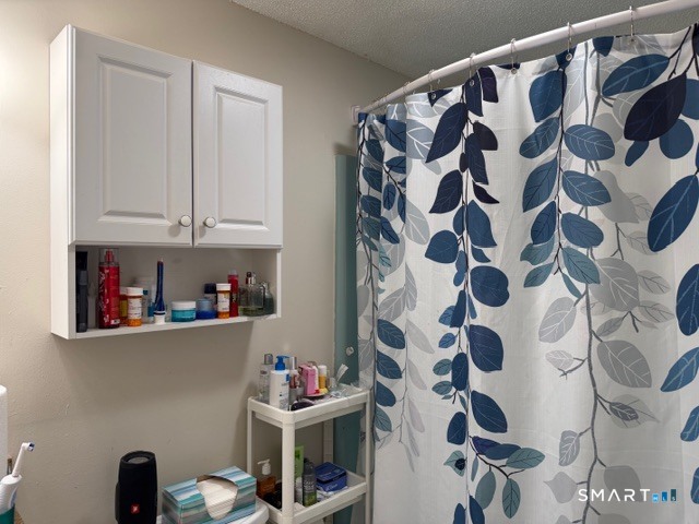 113 Heather Ridge, Unit 113 Shelton, CT 06484 - Photo 13 of 19 a room with a black white checkered floor and a cabinet