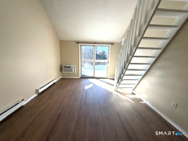 113 Heather Ridge, Unit 113 Shelton, CT 06484 - Photo 3 of 19 wooden floor in an empty room with a window