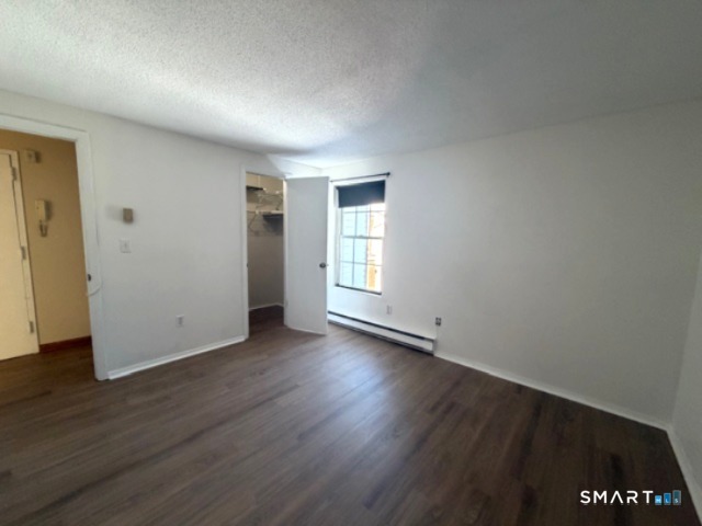 113 Heather Ridge, Unit 113 Shelton, CT 06484 - Photo 10 of 19 an empty room with wooden floor and windows