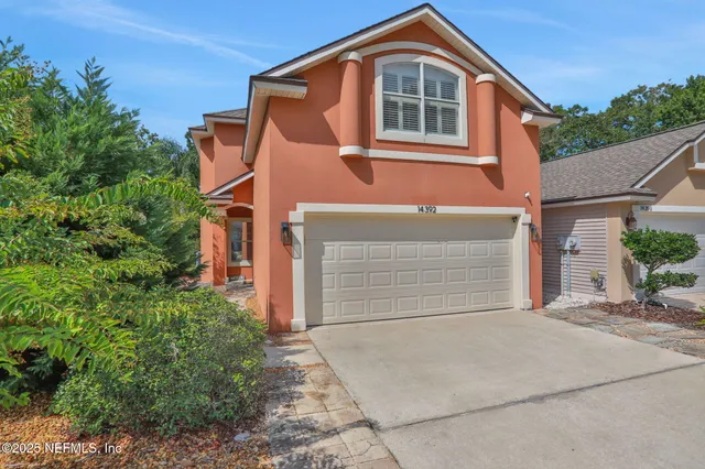 a front view of a house with a garage