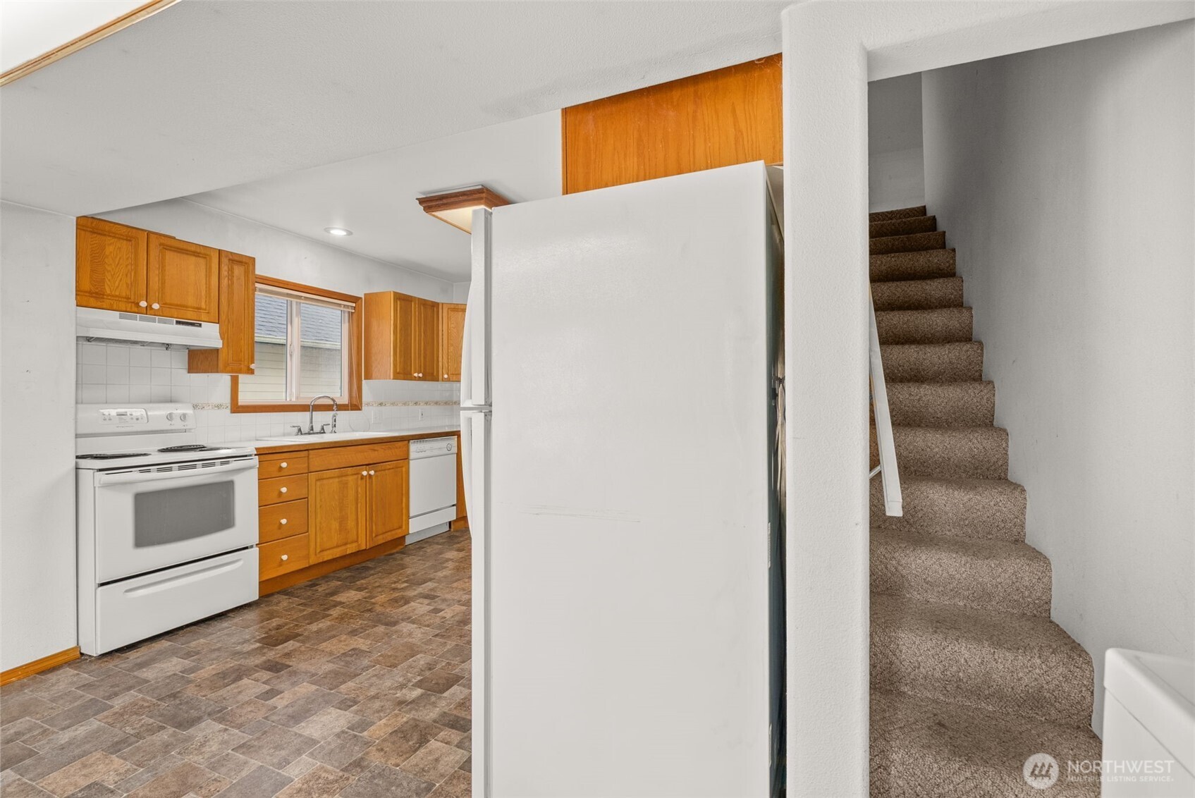 506 East Locust Street Centralia, WA 98531 - Photo 19 of 30 a kitchen with a refrigerator and a sink