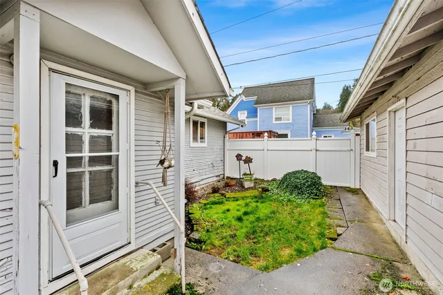 a backyard of a house with table and chairs