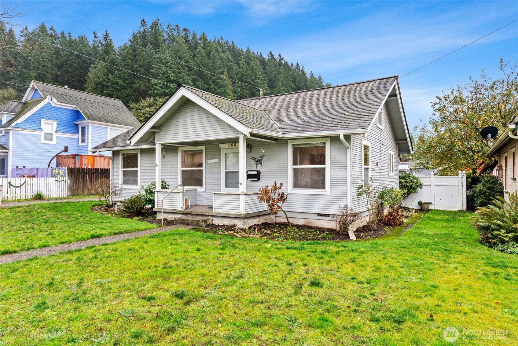 506 East Locust Street Centralia, WA 98531 - Photo 4 of 30 a front view of a house with a yard and trees