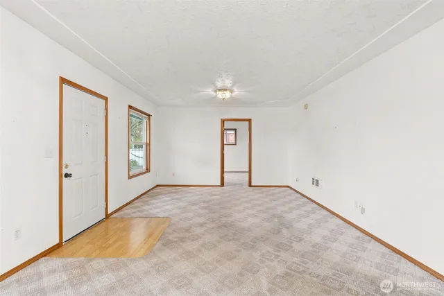 an empty room with windows and closet