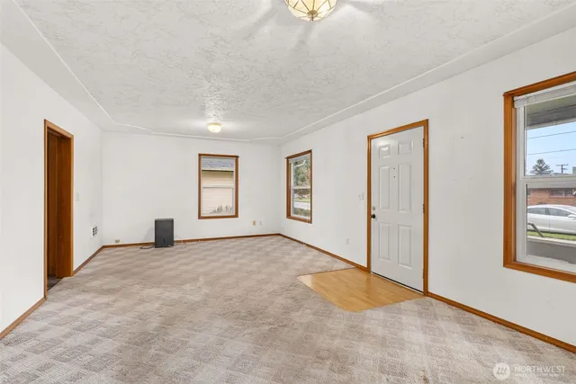 an empty room with windows and closet