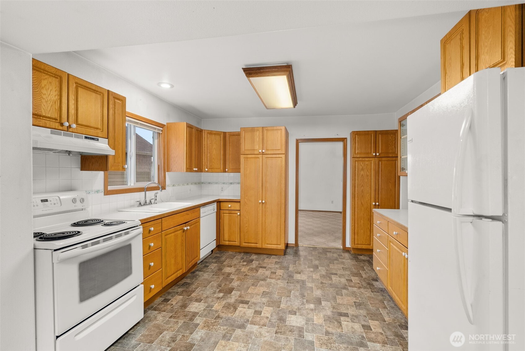 506 East Locust Street Centralia, WA 98531 - Photo 9 of 30 a kitchen with stainless steel appliances granite countertop a stove a refrigerator and a sink