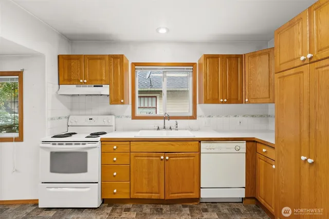 a kitchen with a sink stove and cabinets