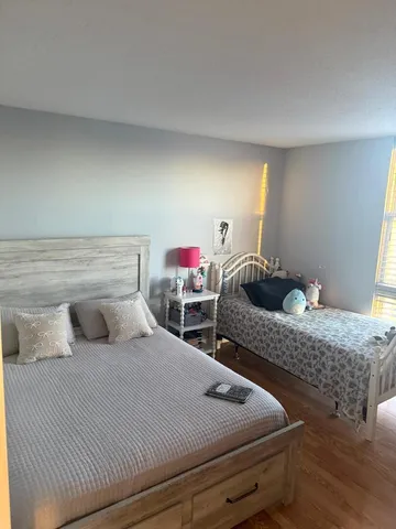 a bedroom with two beds and dresser