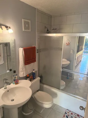 a bathroom with a sink toilet and shower