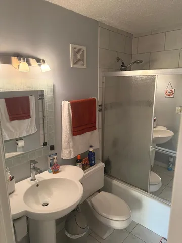a bathroom with a sink toilet and shower