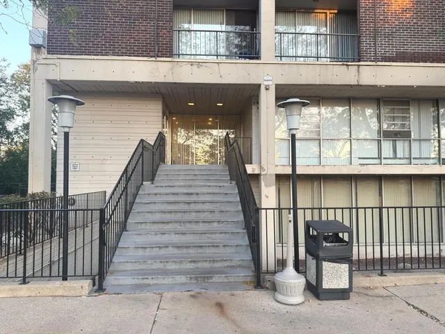 a view of a street with a car parked on the road