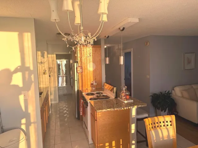 a lobby with furniture and chandelier
