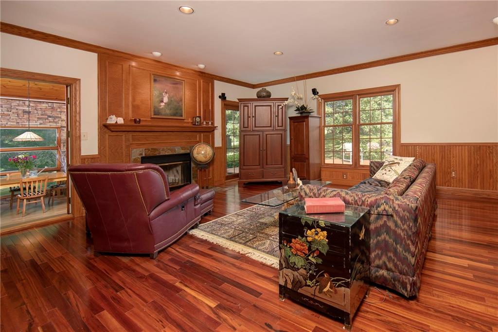 1479 Three Degree Road Mars, PA 16046 - Photo 5 of 24 Large family room with log-burning fireplace (home is all electric. no gas), recessed lighting, Brazilian cherry hardwood flooring and wall-length built-ins (to right; not seen in this partial photo).