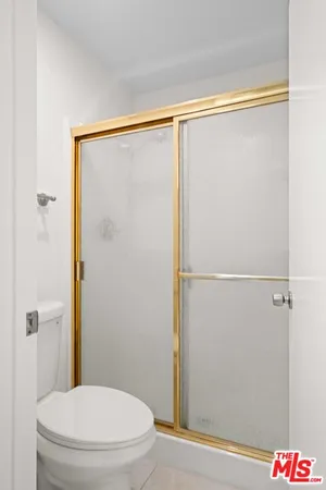 a bathroom with a shower and a toilet