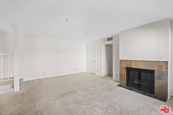 an empty room with a fireplace
