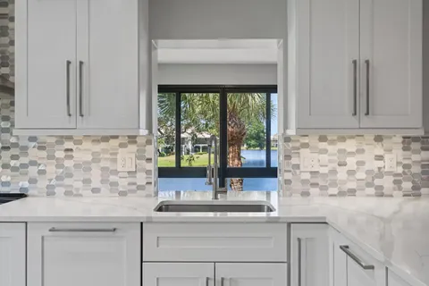 a kitchen with a sink and cabinets