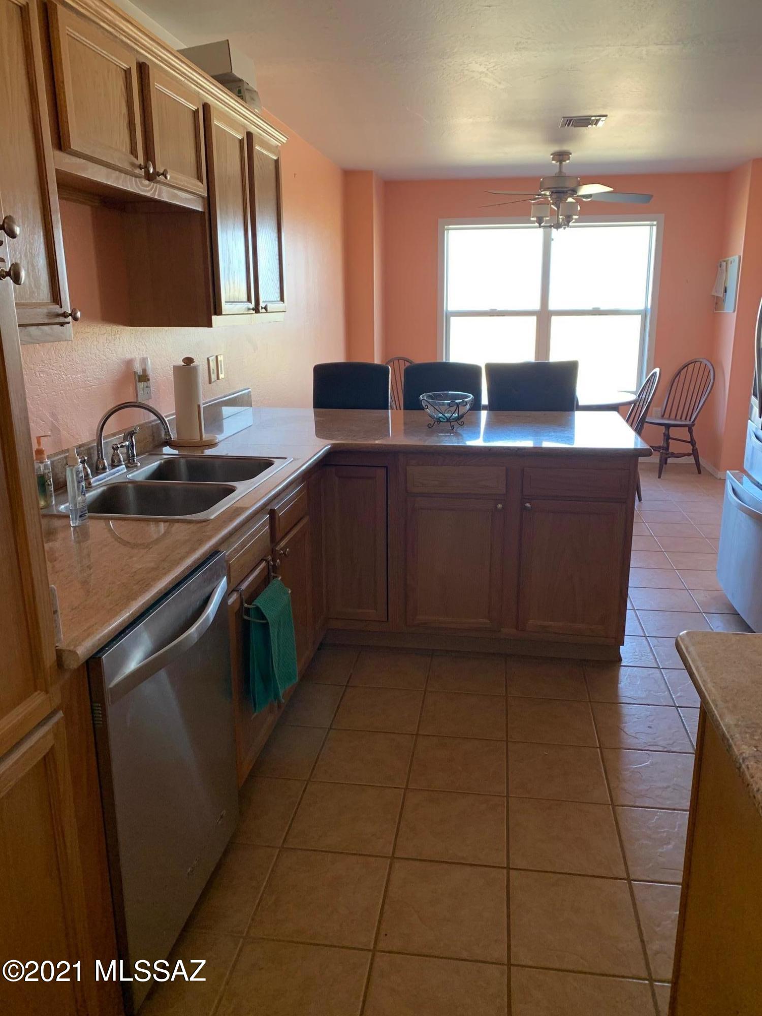 3504 East Howling Wolf Road Willcox, AZ 85643 - Photo 9 of 21 a kitchen with stainless steel appliances granite countertop a sink and a stove