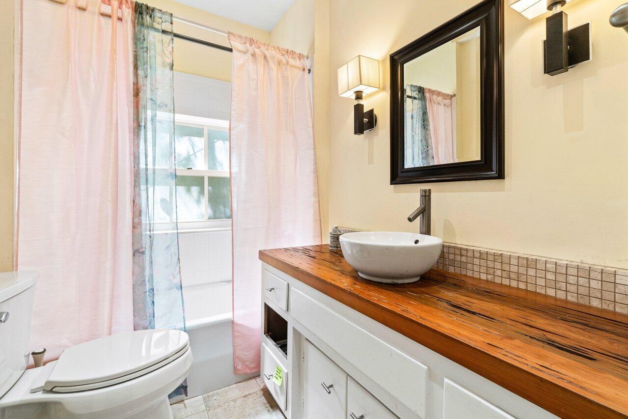 214 List Road Palm Beach, FL 33480 - Photo 14 of 21 a bathroom with a granite countertop sink mirror vanity and toilet