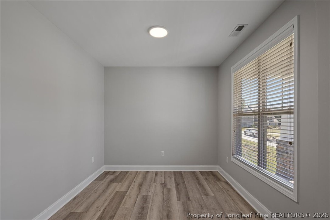 134 Huzzas Circle Cameron, NC 28326 - Photo 4 of 31 wooden floor in an empty room with a window