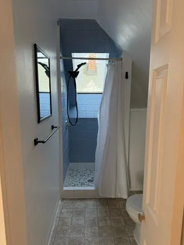 a white toilet sitting next to a bathroom sink