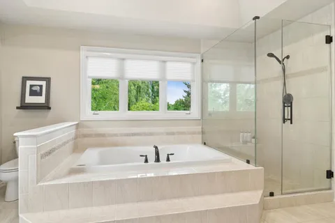 a bathroom with a bathtub and shower