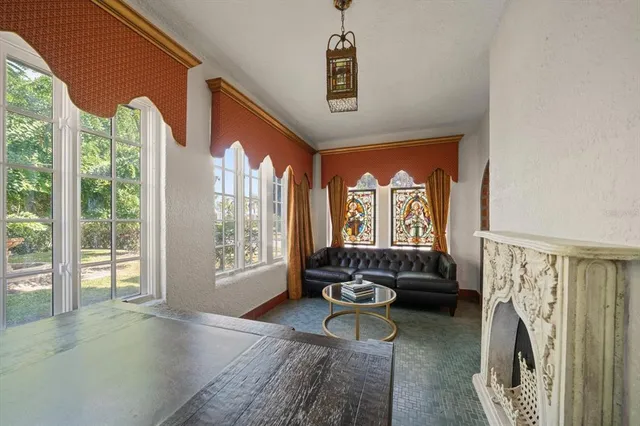 a living room with fireplace furniture and a fireplace