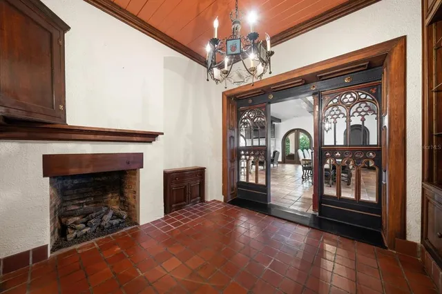 a kitchen with stainless steel appliances granite countertop a stove a refrigerator a kitchen island a table and chairs