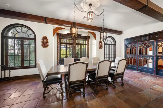 a kitchen with granite countertop white cabinets and a window