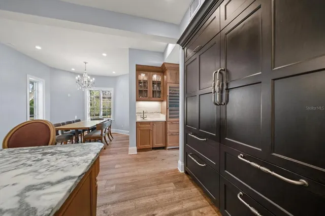 a spacious bathroom with double vanity a mirror a bathtub and a window