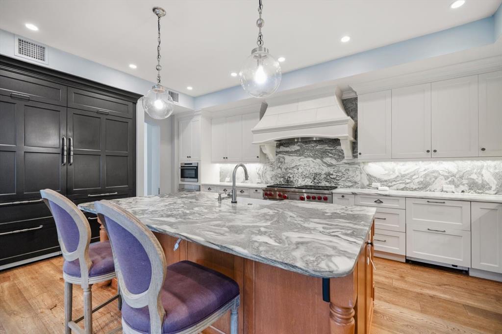 1102 Palmview Avenue Belleair, FL 33756 - Photo 23 of 81 a kitchen with stainless steel appliances granite countertop a kitchen island a stove a table and chairs in it