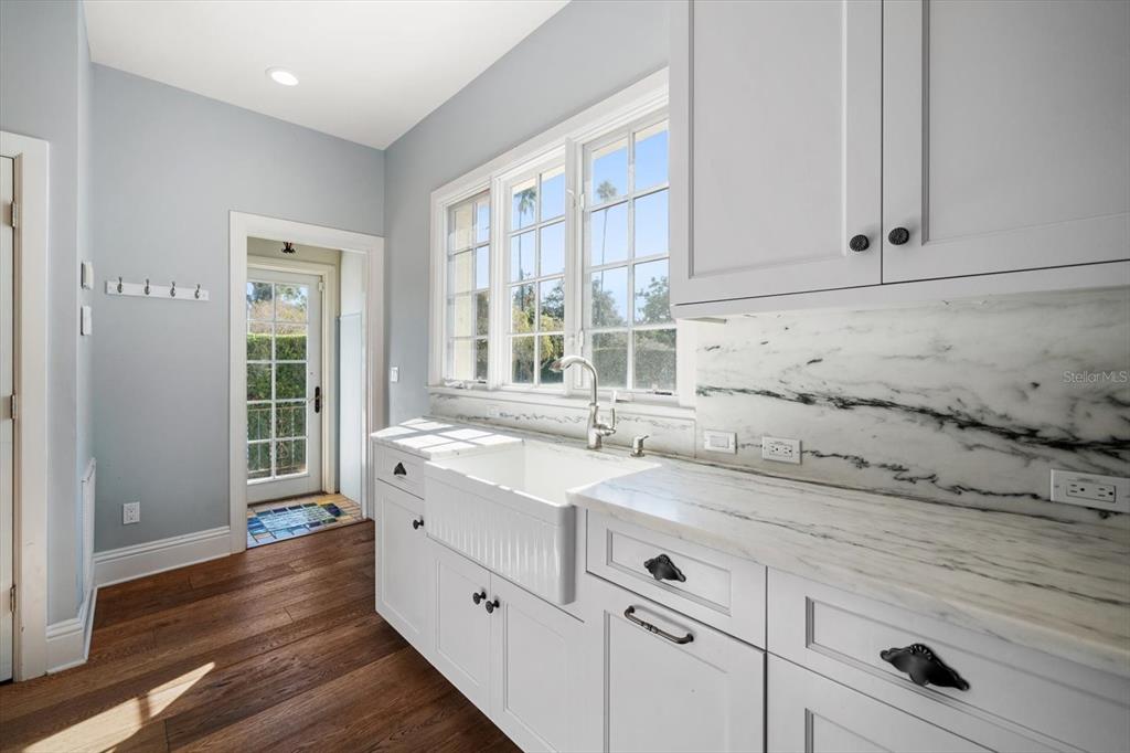 1102 Palmview Avenue Belleair, FL 33756 - Photo 26 of 81 a kitchen with granite countertop white cabinets and a window
