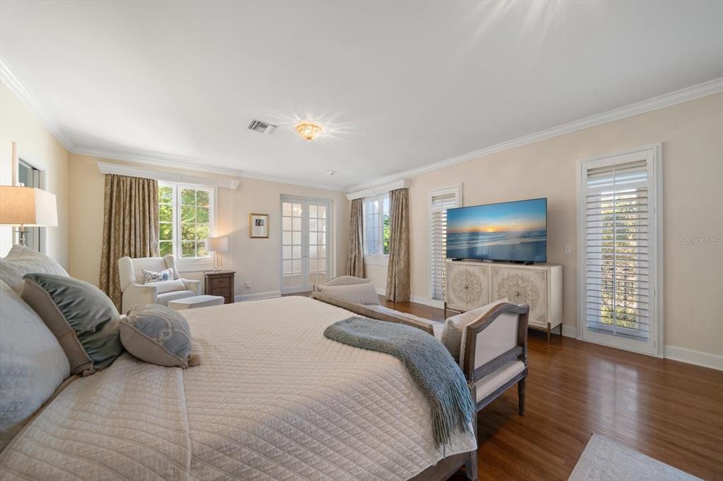 1102 Palmview Avenue Belleair, FL 33756 - Photo 30 of 81 a bedroom with a bed and a flat screen tv